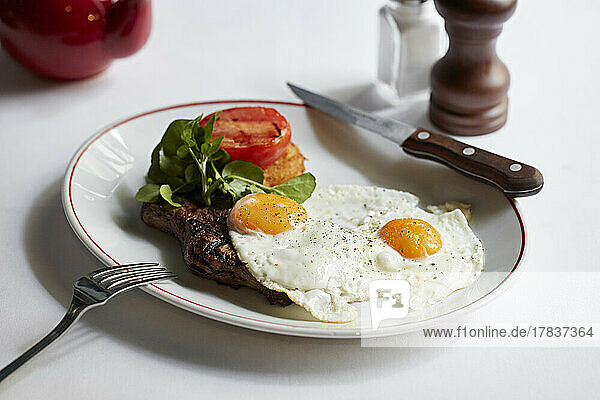 Fillet steak with fried eggs  hashbrown and grilled tomato