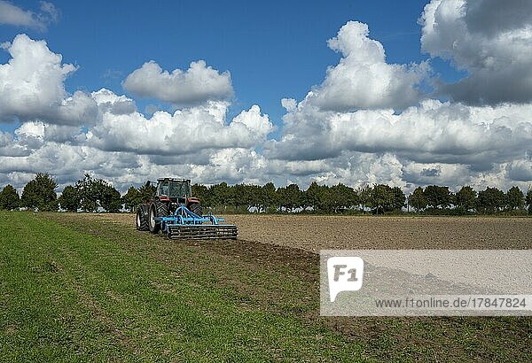 Agriculture  tractor ploughing the field  Berlin  Germany  Europe