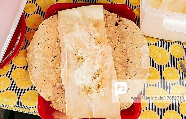 Top view of Nicaraguan Quesillo served on table. Traditional Nicaraguan Quesillo served on a plate on the table. Latin American food Quesillo  Traditional Quesillo with pickled onion