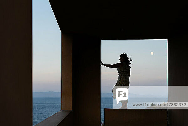 Woman enjoying a beautiful view of sea in Greece