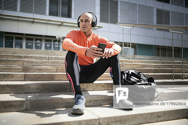 male athlete sitting and resting after street workout session