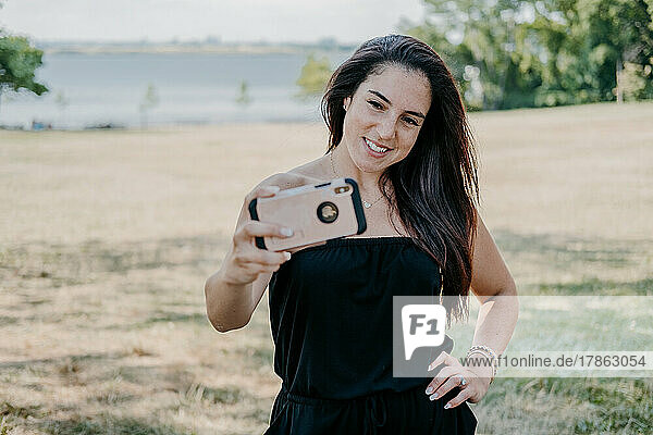 Young Adult Woman Taking Selfie in the park
