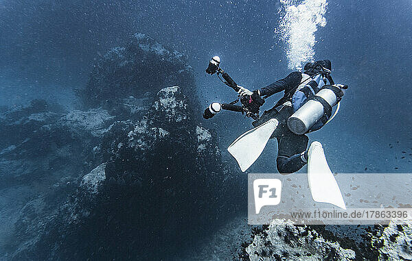underwater photographer exploring the tropical waters around Koh Tao