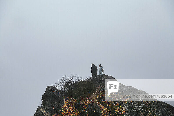 Two hikers in mountain fog  Dagestan  North Caucasus