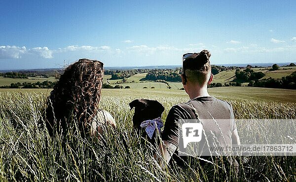 lesbian couple and their dog enjoying a beautiful countryside view