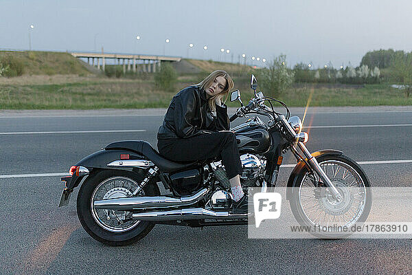 Blonde Woman Sitting On A Motorbike Alone