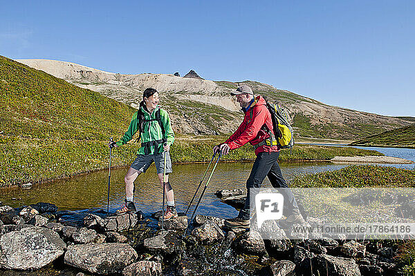 couple hiking in the remote east fjords of Iceland