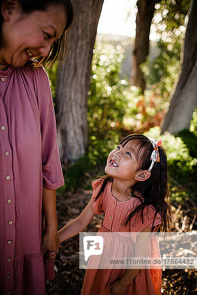 Young Daughter Looking Up at Mom in Park in San Diego