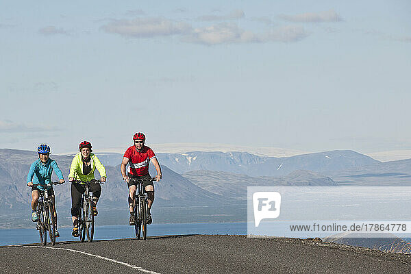 Cyclist riding around the Thingvallavatn lake in Iceland
