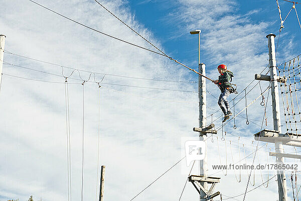 girl using a giant swing at high rope access course in Iceland