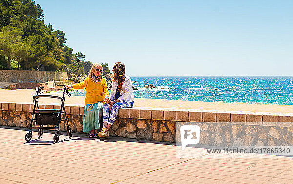 mother and grandmother strolling along the beach