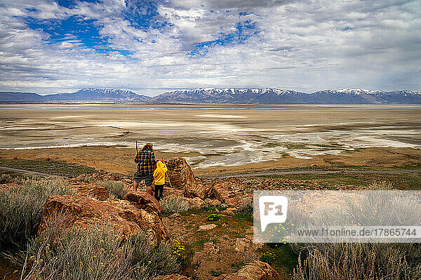 father and son hiking on rocks at antelope island in Utah