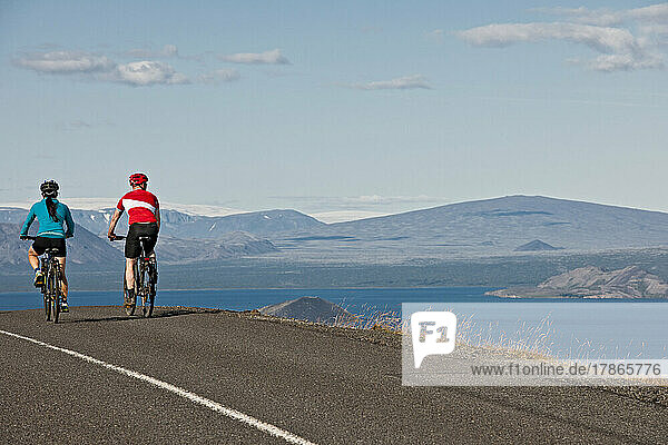 Cyclist riding around the Thingvallavatn lake in Iceland