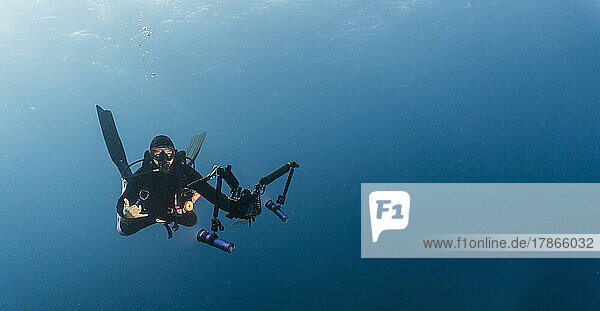 underwater photographer diving at the Tubbataha Reef