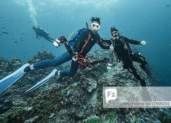 friends diving in the tropical waters at the Andaman Sea in Thailand