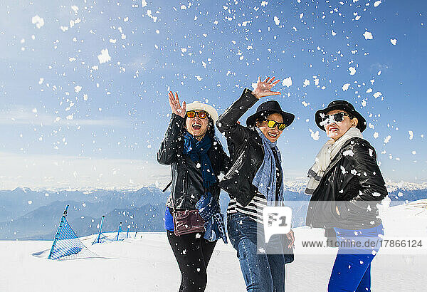 three female friends on top of a mountain above the Lago di Garda lake