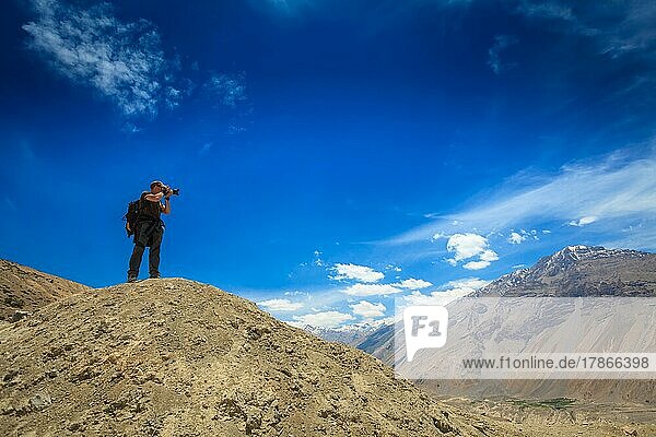 Photographer taking photos in Himalayas mountains. Spiti valley  Himachal Pradesh  India  Asia