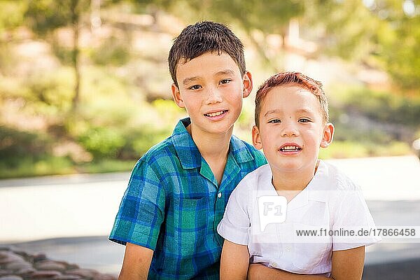 Outdoor portrait of biracial chinese and caucasian brothers