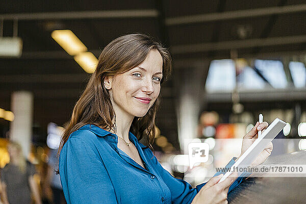 Smiling businesswoman with tablet PC