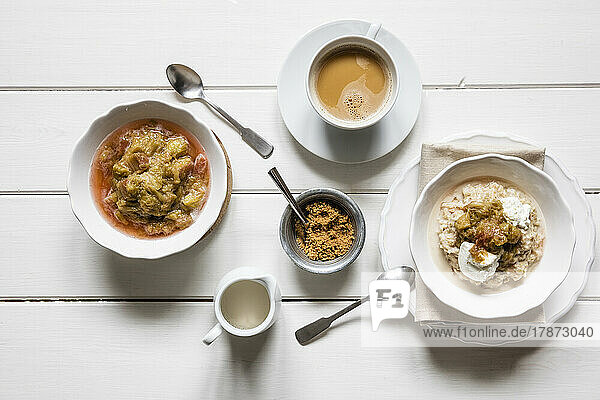 Studio shot of cup of coffee and two bowls of porridge