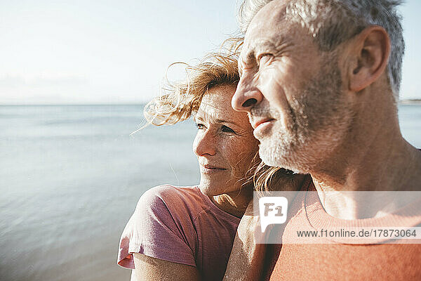 Mature man and woman spending time on vacation at beach