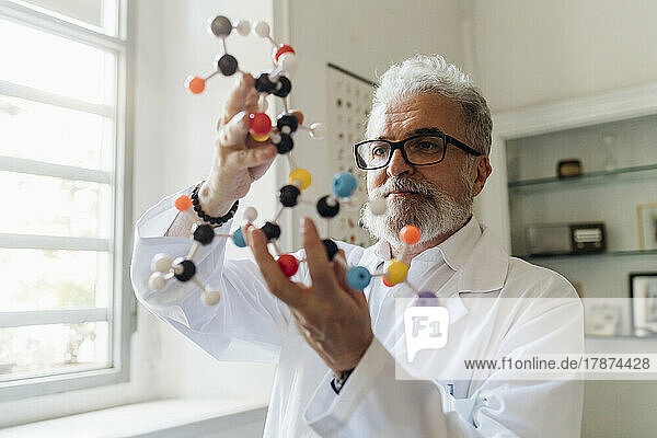 Concentrated scientist analyzing molecular structure in lab