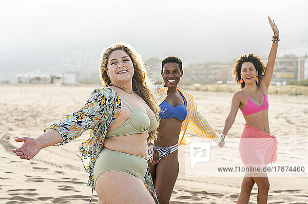 Carefree women dancing at beach