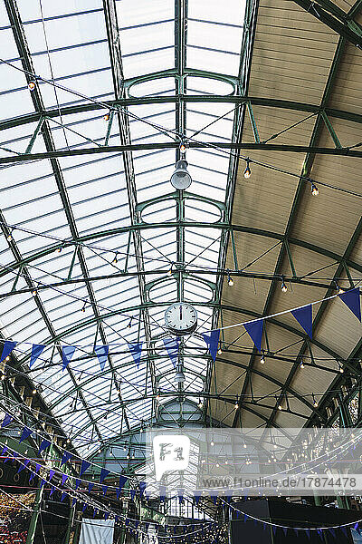 Lights and bunting decoration hanging from ceiling at railroad station