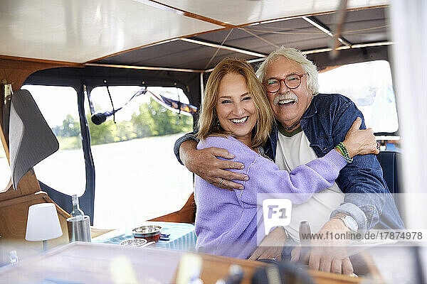 Happy senior couple embracing each other in boat
