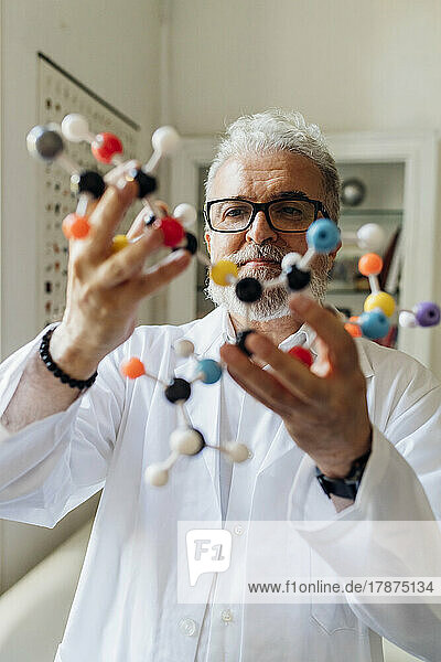 Scientist examining molecular structure in lab