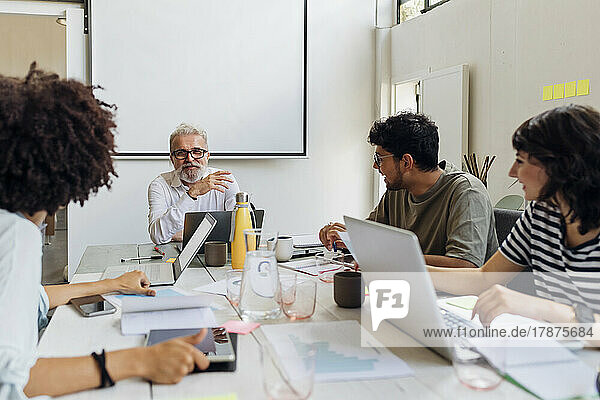 Senior manager discussing with colleagues in office