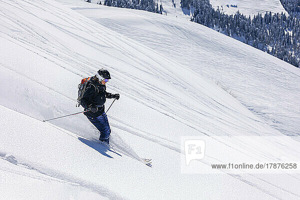 Skier skiing on snowy mountain
