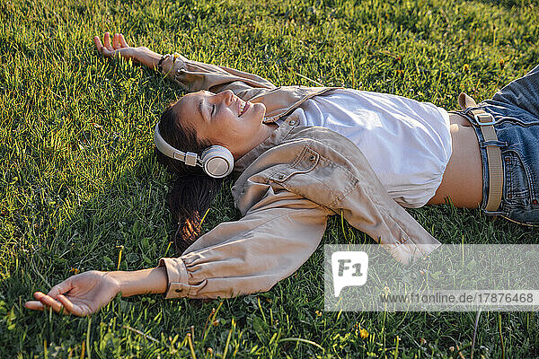 Woman lying down on grass at park