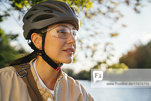 Woman with cycling helmet and protective eyewear at park