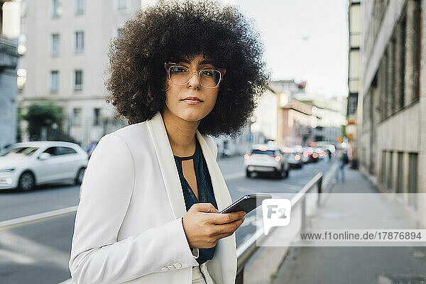 Young Afro businesswoman with mobile phone