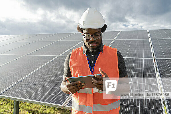 Engineer using tablet PC at solar station