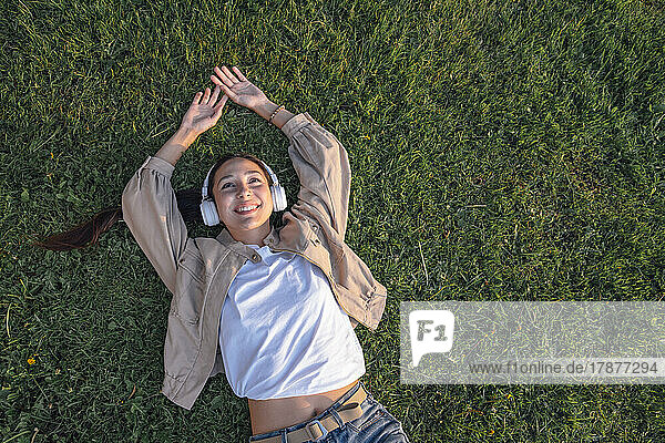 Smiling lying down on grass at park