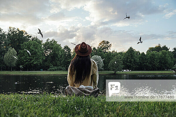 Woman looking at lake sitting in park