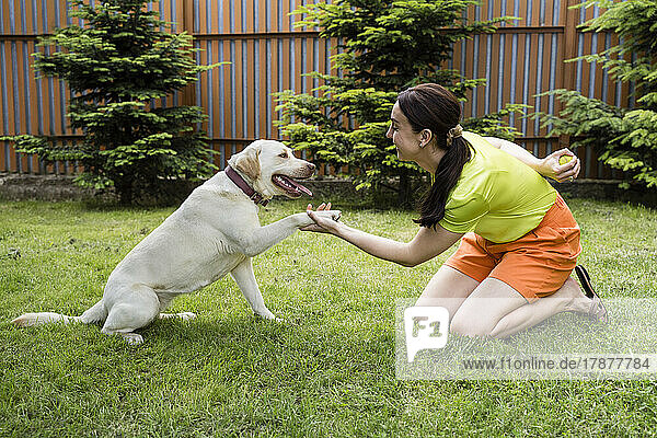 Happy woman with dog at back yard
