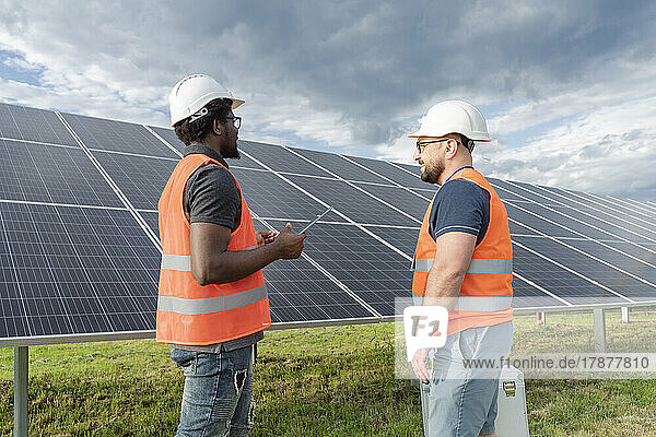 Multiracial engineers having discussion at solar station