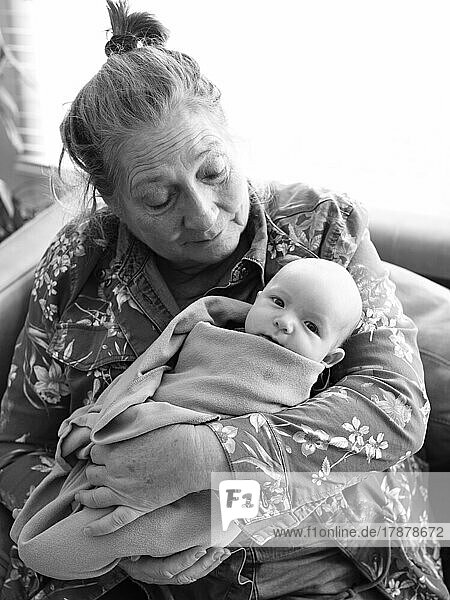 Grandmother holding newborn grandson (0-1 months)