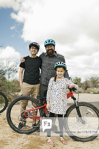 Portrait of father with children (8-9  14-15) with bikes