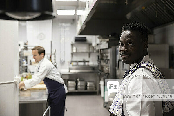 Portrait of confident chef standing in kitchen of restaurant