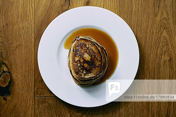 Still life stack of pancakes with maple syrup on plate