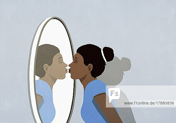 Woman kissing reflection in mirror