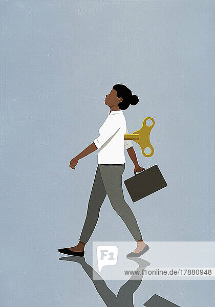 Windup businesswoman walking with briefcase on blue background