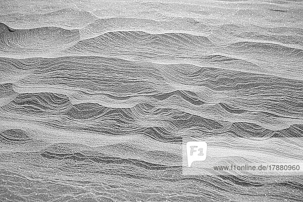 Rippled lines forming pattern on icy snow landscape