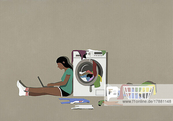 Girl using laptop and doing laundry at clothes dryer