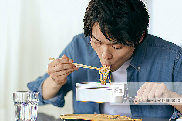 Japanese man eating at home