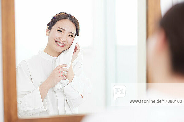 Japanese woman washing face at home